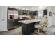 Stylish kitchen with black cabinets, stainless steel appliances, and a center island with seating at 4694 Monica St, The Villages, FL 32163
