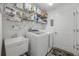 Functional laundry room with washer, dryer, utility sink, shelving and storage at 4694 Monica St, The Villages, FL 32163