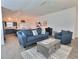 Open-concept living room featuring modern furnishings and seamless flow to the kitchen and dining area at 4694 Monica St, The Villages, FL 32163