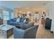Bright and airy living space with wood floors, seamlessly connected to the kitchen and dining area at 4694 Monica St, The Villages, FL 32163
