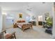 Comfortable main bedroom featuring a ceiling fan, carpeted floor, and ensuite bathroom at 4694 Monica St, The Villages, FL 32163