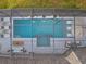 Aerial view of a backyard featuring a pool, spa, lounge area, and screened-in enclosure at 489 Avila Pl, Howey In The Hills, FL 34737