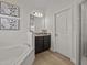 Bathroom with a soaking tub, granite-topped vanity and drawers, tile backsplash, and shower with glass door at 489 Avila Pl, Howey In The Hills, FL 34737