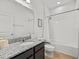 Well-lit bathroom with granite countertop vanity and a shower-tub combo with tile surround at 489 Avila Pl, Howey In The Hills, FL 34737