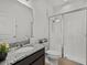 Clean bathroom with a shower, toilet, and dark vanity with a light granite countertop and vessel sink at 489 Avila Pl, Howey In The Hills, FL 34737