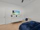 Comfortable bedroom with TV mounted over dresser, complemented by a chair for relaxation at 489 Avila Pl, Howey In The Hills, FL 34737
