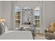 Bedroom featuring a vanity with lighted mirror and arched windows, offering great natural light at 489 Avila Pl, Howey In The Hills, FL 34737
