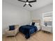 Cozy bedroom features a plush blue comforter and chair, complemented by a modern ceiling fan at 489 Avila Pl, Howey In The Hills, FL 34737