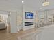 Bright bedroom featuring an electric fireplace, hardwood floors and large windows at 489 Avila Pl, Howey In The Hills, FL 34737