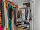 Organized closet with clothing on hangers and folded items on shelves, plus shoe rack at 489 Avila Pl, Howey In The Hills, FL 34737