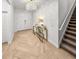 Elegant entryway with a crystal chandelier, herringbone wood floors, and stairs leading to the upper level at 489 Avila Pl, Howey In The Hills, FL 34737