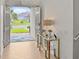 Bright entryway with herringbone floors, a modern glass console table, and an open view to the front yard at 489 Avila Pl, Howey In The Hills, FL 34737