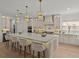 Open-concept kitchen with a large island, pendant lights, stainless steel appliances, custom cabinetry and bar stool seating at 489 Avila Pl, Howey In The Hills, FL 34737