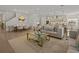 Open-concept living space with a modern sofa, a dining area, and a kitchen with a large center island at 489 Avila Pl, Howey In The Hills, FL 34737