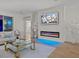 Bright and airy living room with wood floors, a modern fireplace, and sliding glass doors leading to the outside at 489 Avila Pl, Howey In The Hills, FL 34737