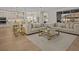 Spacious living room with modern furniture, an open layout, and a view into the well-equipped kitchen at 489 Avila Pl, Howey In The Hills, FL 34737