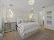 Elegant main bedroom featuring a padded headboard, mirrored nightstands, and a stylish crystal chandelier at 489 Avila Pl, Howey In The Hills, FL 34737