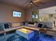 This covered outdoor patio features a modern fire pit table, comfy seating and an open view to the interior at 489 Avila Pl, Howey In The Hills, FL 34737