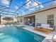 Wonderful outdoor living and pool area with screened-in enclosure and comfortable patio furniture at 489 Avila Pl, Howey In The Hills, FL 34737
