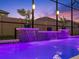 This in-ground pool offers a tile waterfall feature, accent lighting, and potted plants for an inviting atmosphere at 489 Avila Pl, Howey In The Hills, FL 34737