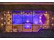 Aerial view of an illuminated rectangular pool surrounded by lounge chairs and a contemporary metal structure at 489 Avila Pl, Howey In The Hills, FL 34737