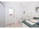 Functional bathroom with a single vanity, toilet, and access to the exterior at 577 Sunridge Woods Blvd, Davenport, FL 33837