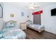 Well-lit bedroom with twin beds, playful decor, and wood-look floors at 577 Sunridge Woods Blvd, Davenport, FL 33837