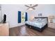 Comfortable bedroom features wood-look flooring, a large bed, and natural lighting at 577 Sunridge Woods Blvd, Davenport, FL 33837