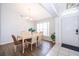 Well-lit dining area featuring modern chandelier and beautiful floors at 577 Sunridge Woods Blvd, Davenport, FL 33837