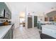 Bright kitchen with stainless steel appliances, white countertops, and tiled floor at 577 Sunridge Woods Blvd, Davenport, FL 33837