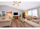 Spacious living room with hardwood floors, neutral paint, and large windows at 577 Sunridge Woods Blvd, Davenport, FL 33837