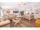 Spacious living room with hardwood floors, neutral paint, and large windows at 577 Sunridge Woods Blvd, Davenport, FL 33837