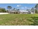 Wide view of the home's exterior, featuring a spacious yard at 12009 Sw 61St Place Road, Ocala, FL 34481