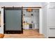 Stylish bar features a sliding barn door, wine storage, custom cabinets, and a copper sink at 12009 Sw 61St Place Road, Ocala, FL 34481