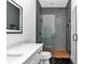 Modern bathroom with gray tile shower, white vanity, and black herringbone floors at 12009 Sw 61St Place Road, Ocala, FL 34481