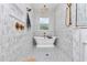 Elegant bathroom featuring a standalone tub, high-end finishes, decorative tile, and brass fixtures at 12009 Sw 61St Place Road, Ocala, FL 34481
