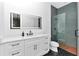 Modern bathroom with sleek vanity, black hardware, subway tile shower, and black herringbone floors at 12009 Sw 61St Place Road, Ocala, FL 34481