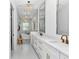 Modern bathroom features a freestanding tub, dual vanity with sleek cabinetry, designer lighting and tile at 12009 Sw 61St Place Road, Ocala, FL 34481