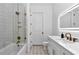 Luxurious bathroom showcasing glass-enclosed shower, white vanity, illuminated mirror, and stylish fixtures at 12009 Sw 61St Place Road, Ocala, FL 34481
