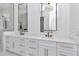 Bathroom features sleek dual vanity with stone countertops, modern hardware, and decorative mirrors at 12009 Sw 61St Place Road, Ocala, FL 34481