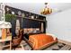Eclectic bedroom with a black accent wall, unique light fixture, and stylish decor at 12009 Sw 61St Place Road, Ocala, FL 34481