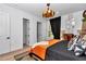Airy bedroom with a black accent wall, stylish decor, and natural light at 12009 Sw 61St Place Road, Ocala, FL 34481