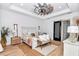 Cozy bedroom with accent wall, decorative ceiling fan, and sliding door at 12009 Sw 61St Place Road, Ocala, FL 34481