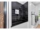 Beautifully designed dog shower in the laundry room with sleek black tile and convenient access to the washer and dryer at 12009 Sw 61St Place Road, Ocala, FL 34481