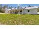Bright, farmhouse-style home featuring board and batten siding, a metal roof, and a charming front porch at 12009 Sw 61St Place Road, Ocala, FL 34481