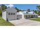 Stunning home with an attached garage and a white exterior with a metal roof, offering both style and functionality at 12009 Sw 61St Place Road, Ocala, FL 34481