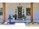 Charming front porch featuring decorative plants, a fountain, and a stylish chandelier, enhancing curb appeal at 12009 Sw 61St Place Road, Ocala, FL 34481