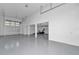 Spacious garage featuring high ceilings, ample space, and a large roll-up door for easy access and plenty of natural light at 12009 Sw 61St Place Road, Ocala, FL 34481