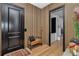 Hallway featuring unique vertical paneling and leading to a laundry room at 12009 Sw 61St Place Road, Ocala, FL 34481