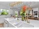 Bright and airy kitchen with white cabinetry, gold fixtures, and modern chandeliers at 12009 Sw 61St Place Road, Ocala, FL 34481